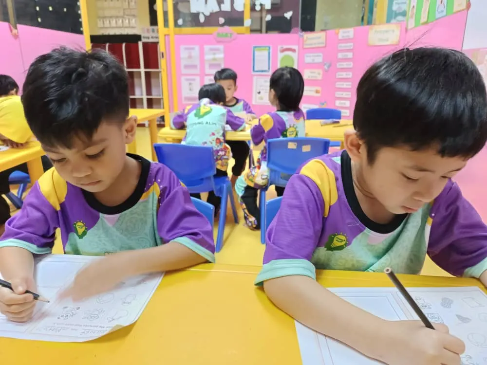 Young Alim student reading and writing